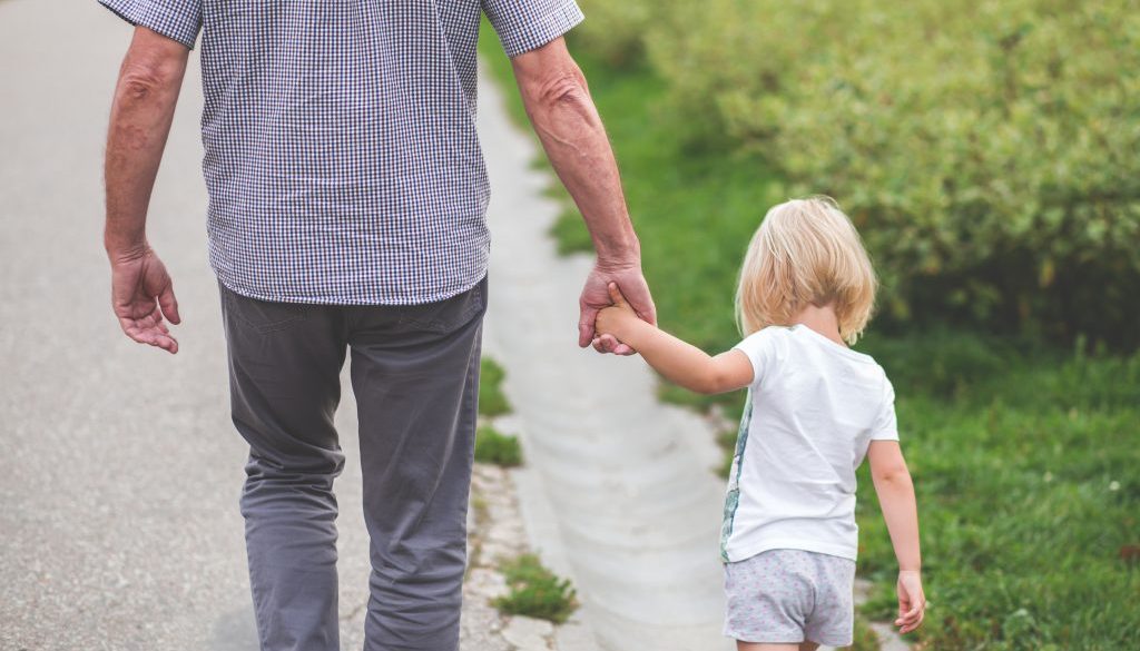 man-and-child-walking-near-bushes-during-daytime-167300