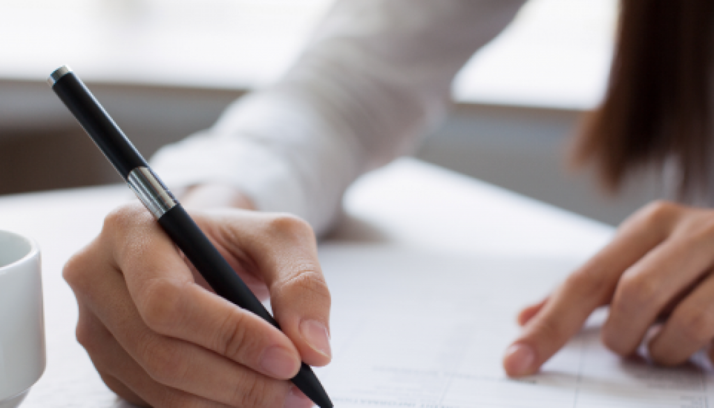 a-woman-filling-out-forms